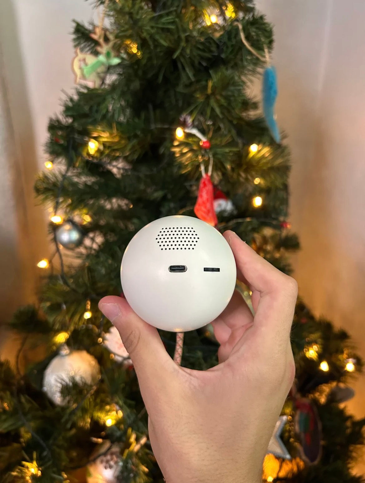 Glowmory memory ornament glowing on a Christmas tree